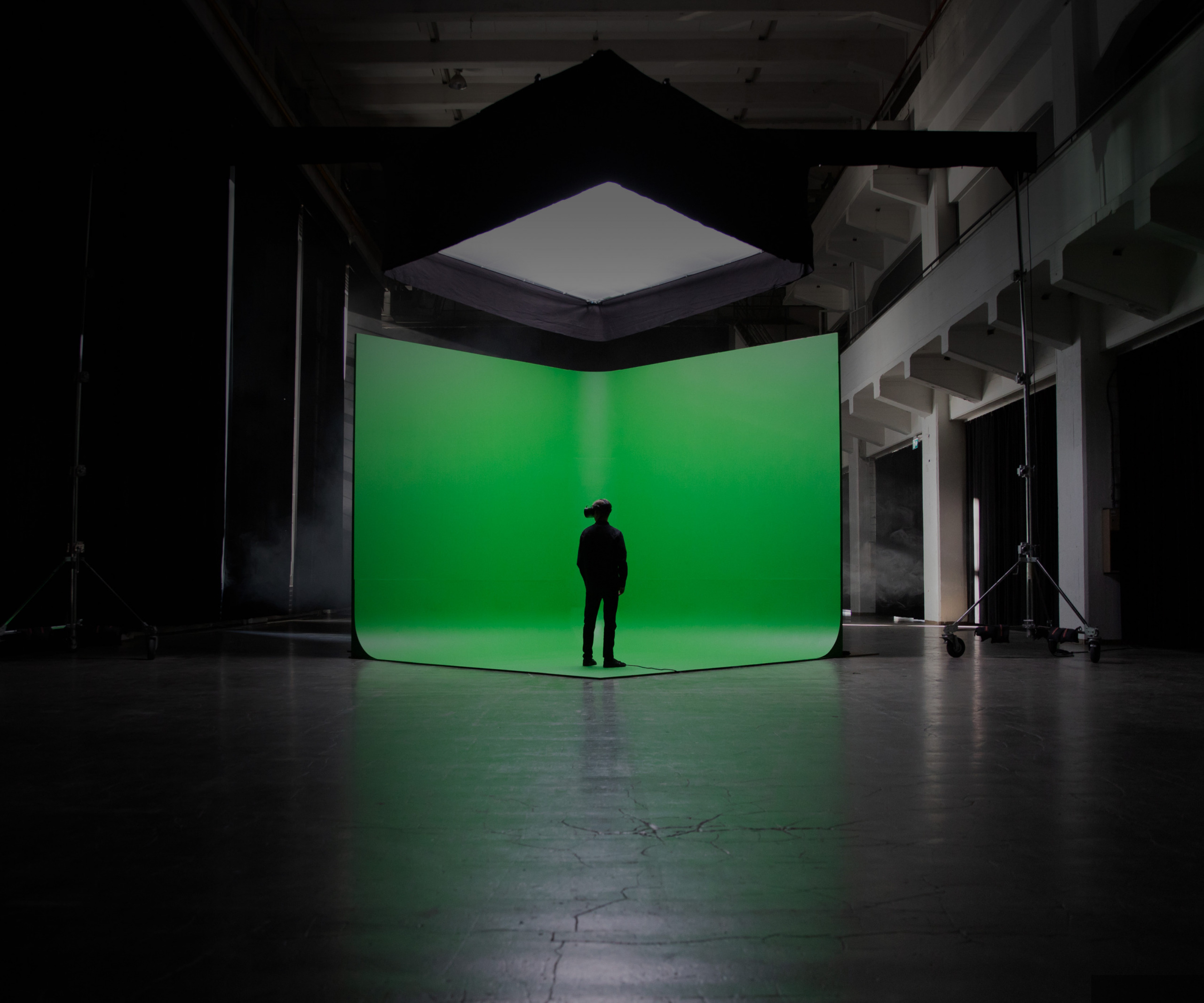 person standing in front of green screen wearing Varjo headset